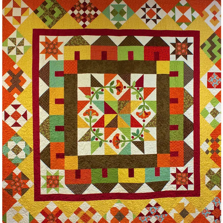 Quilted wall hanging on a wall in a room, featuring a colorful design of a house