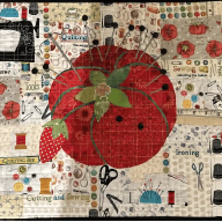 Quilted wall hanging with a red tomato on it