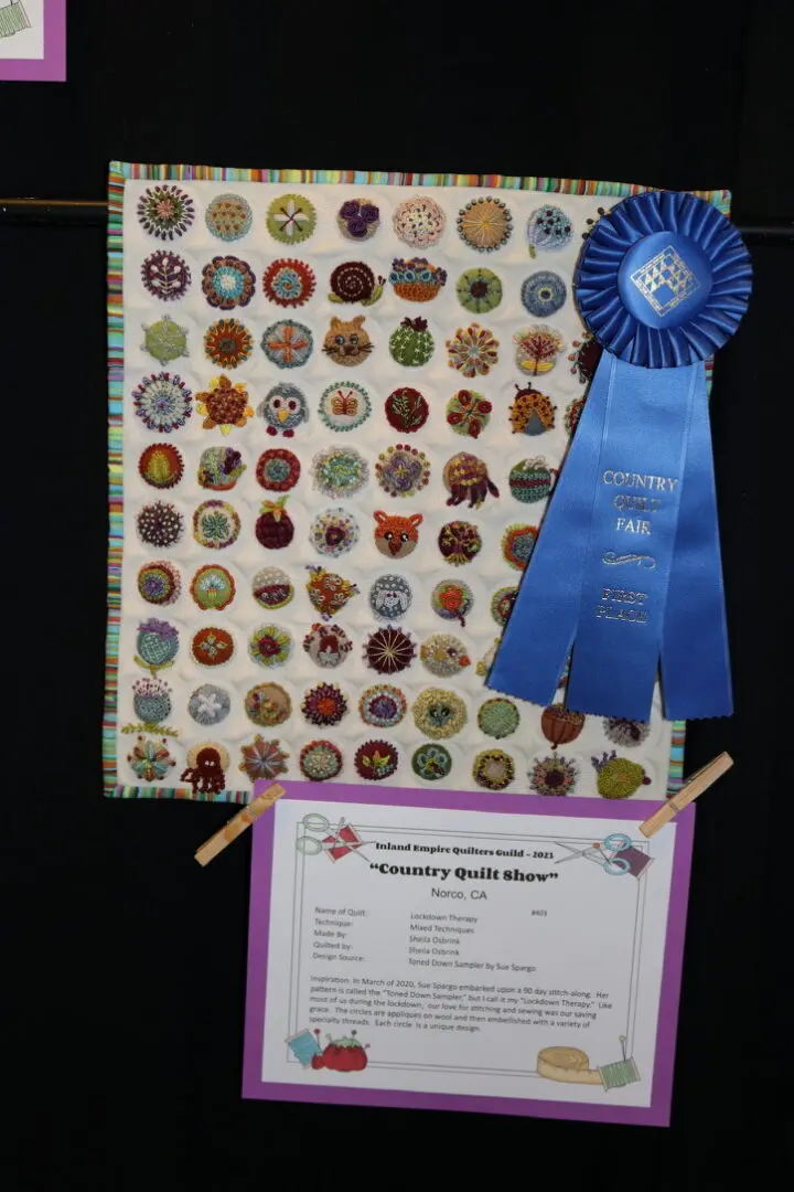 Before and after: Quilt with a blue ribbon hanging on a wall next to a piece of paper