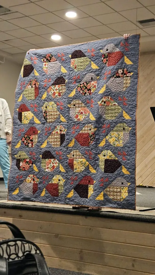 Handmade textile art with colorful bird patterns