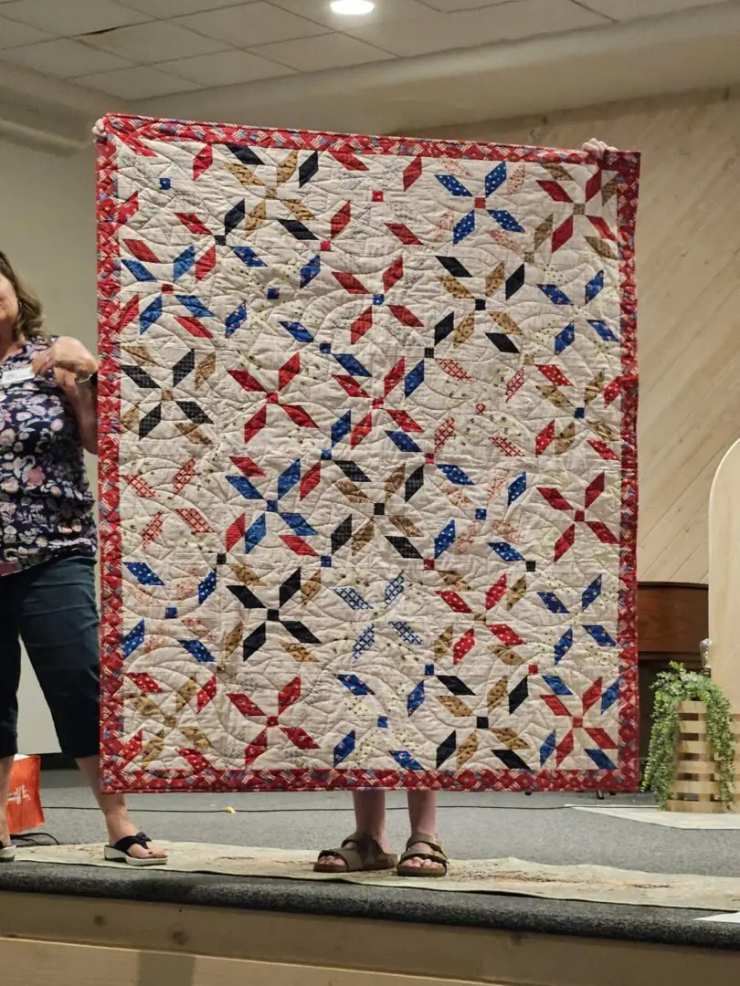 Handmade quilt displayed on stage