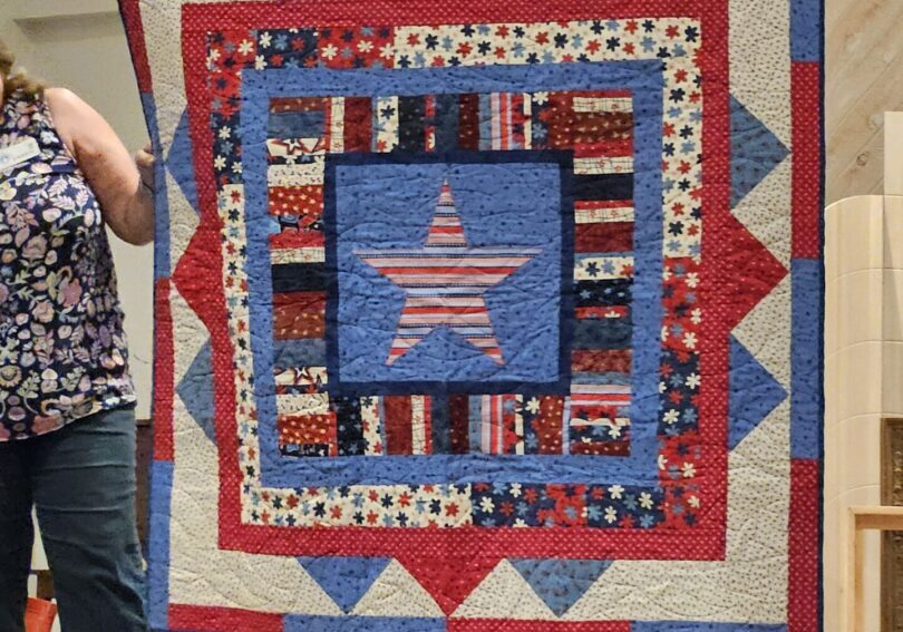 Handmade American-themed quilt presented